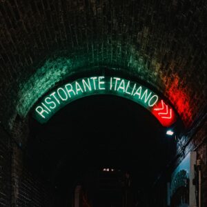 a dark tunnel with a neon sign above it