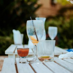 Enjoy a serene outdoor setting in Malindi with empty glasses on a white wooden table, ideal for relaxation.