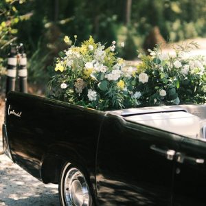 a black car with white flowers